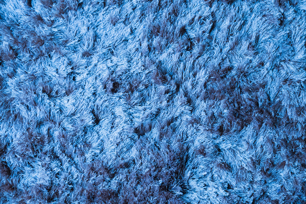 Blue fabric carpet with long pile texture background